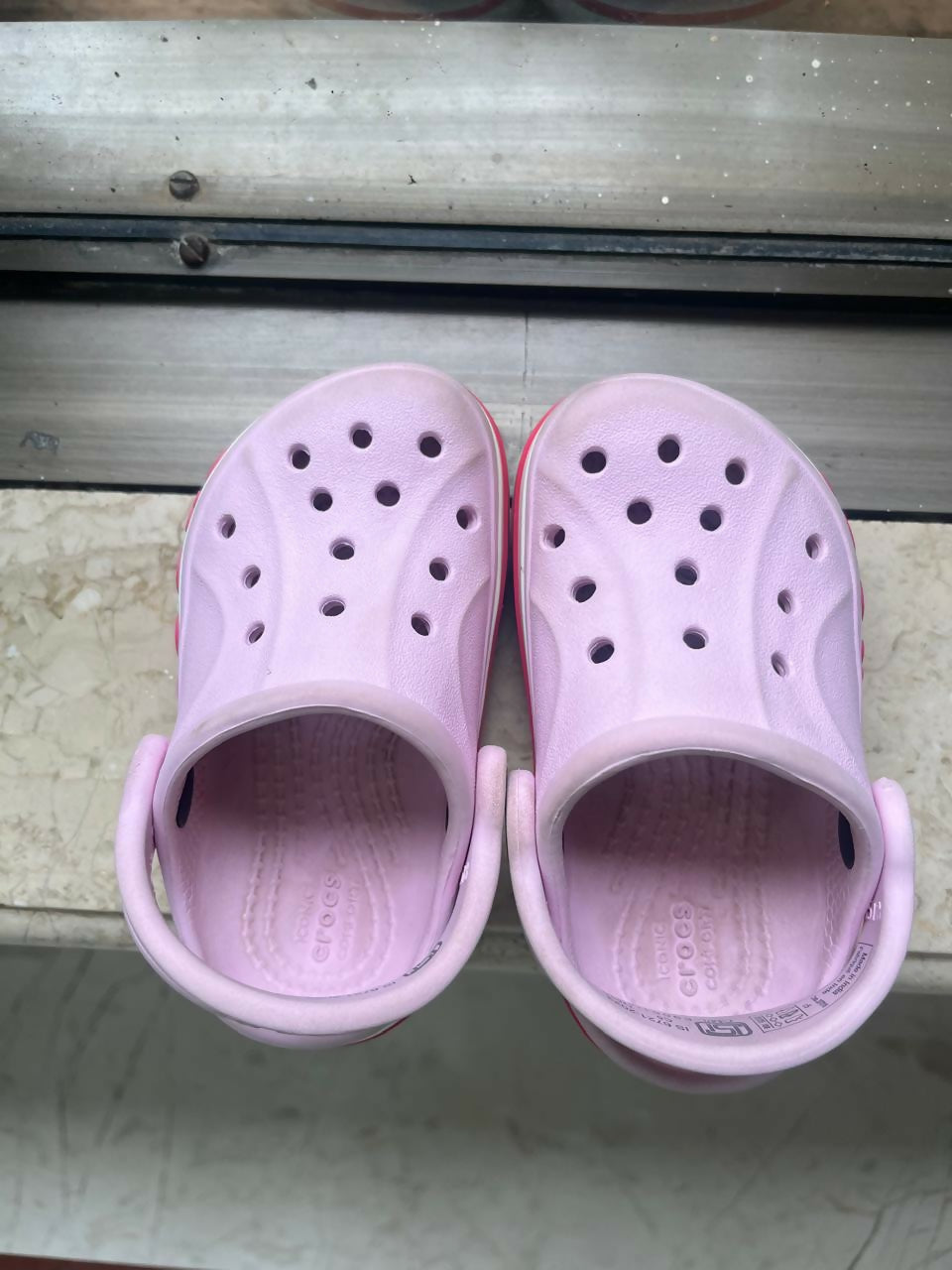 Pink Crocs for Kids in size C5 / 5.1 inches, featuring a lightweight, comfortable and easy-to-wear clog design with ventilation holes for everyday casual wear, playtime and outings.