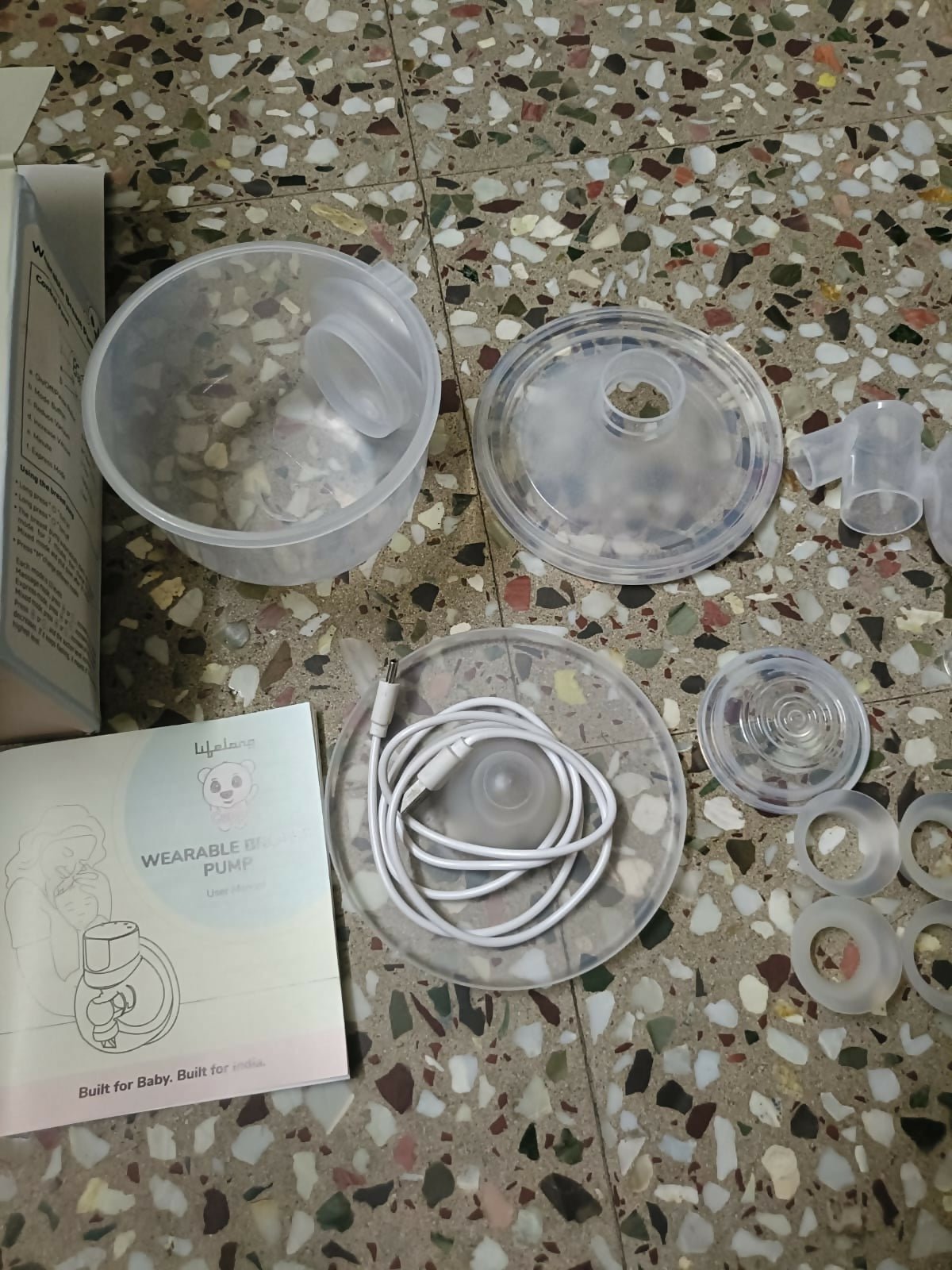 Lifelong Cuppy wearable breast pump with hands-free design, adjustable suction levels, lightweight collection cups, and rechargeable operation for comfortable and discreet milk expression.