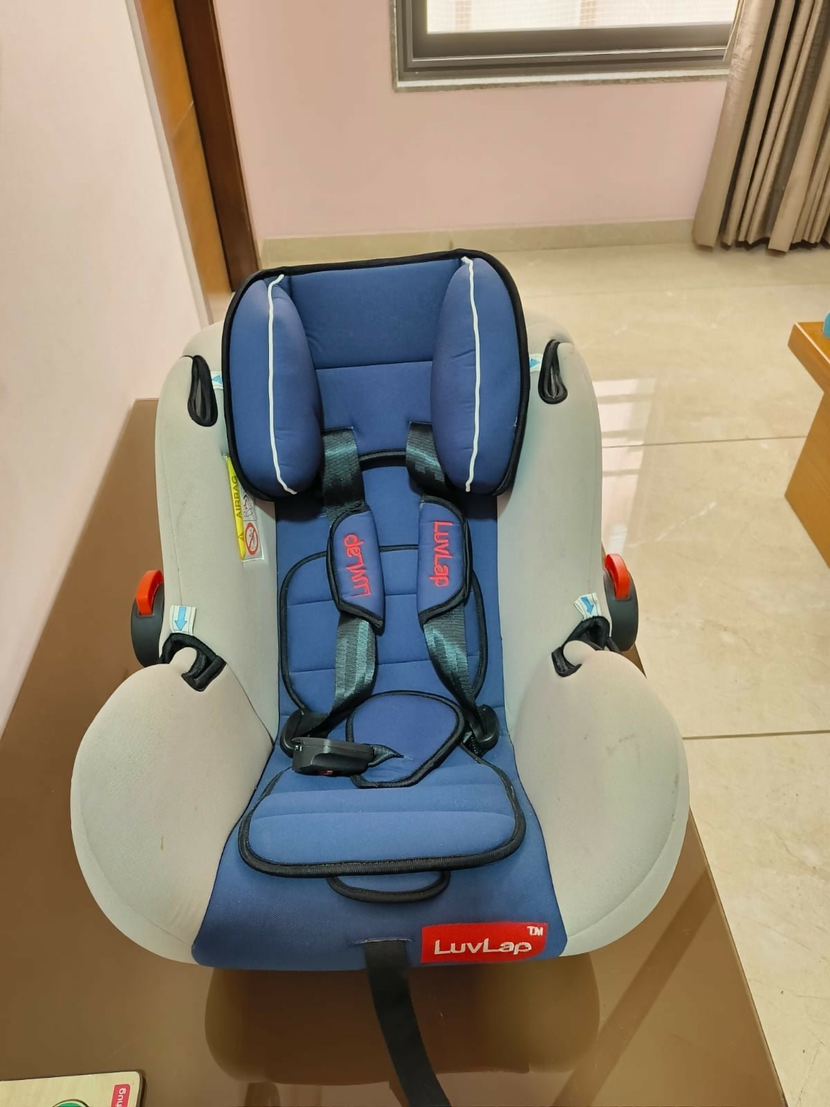 LUVLAP Infant Car Seat with a 5-point safety harness, ergonomic carry handle, side-impact protection, soft padded seating, and lightweight design for safe and comfortable travel with newborns and infants.