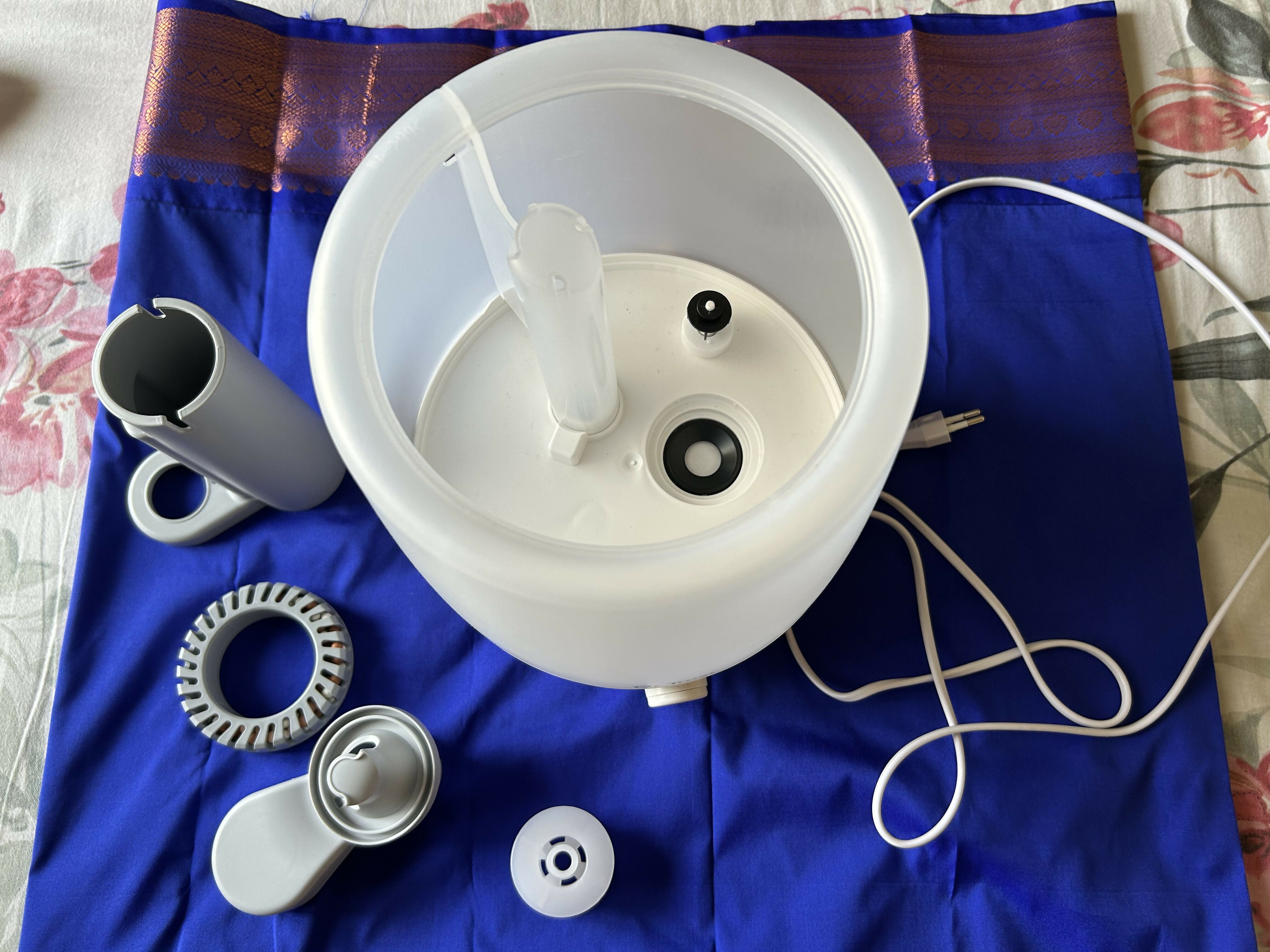 White electronic device with components on a blue fabric background