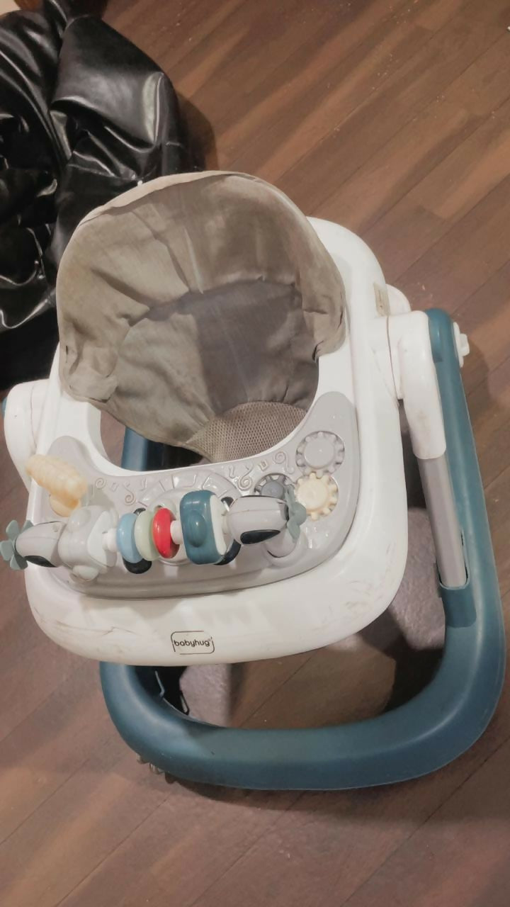 BABYHUG baby walker with sturdy frame, padded seat, and toy tray for safe first steps.