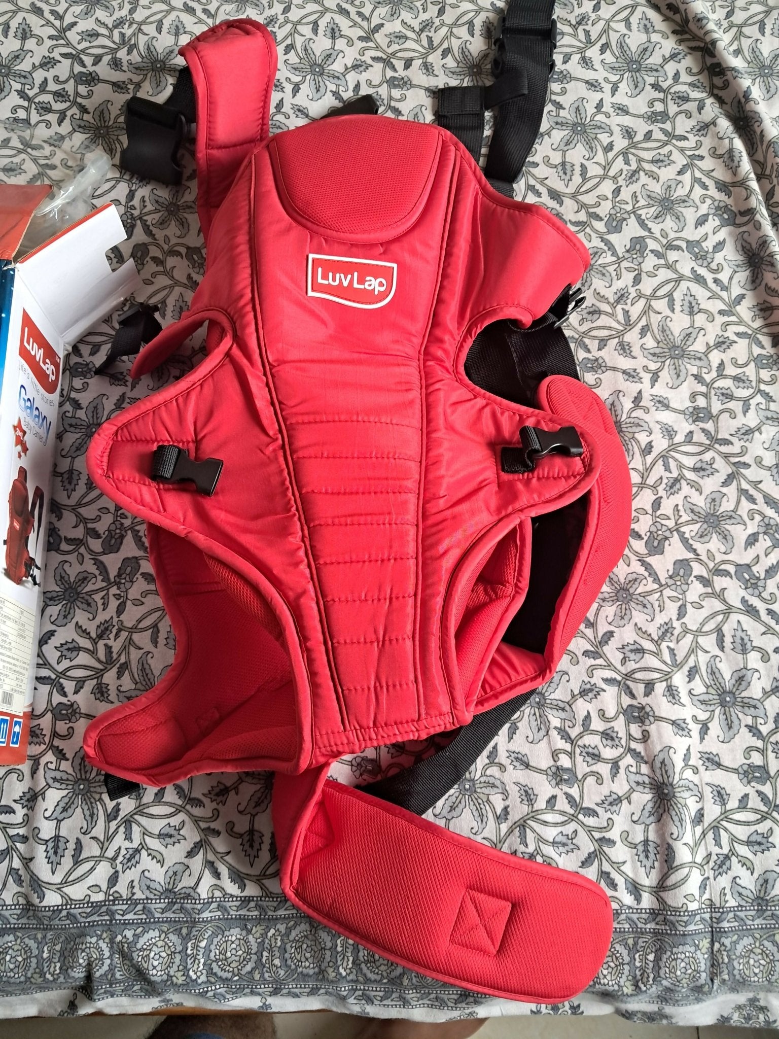 LuvLap Galaxy baby carrier in red with ergonomic support, adjustable straps, cushioned comfort, secure carrying design, and hands-free convenience for babies and parents.