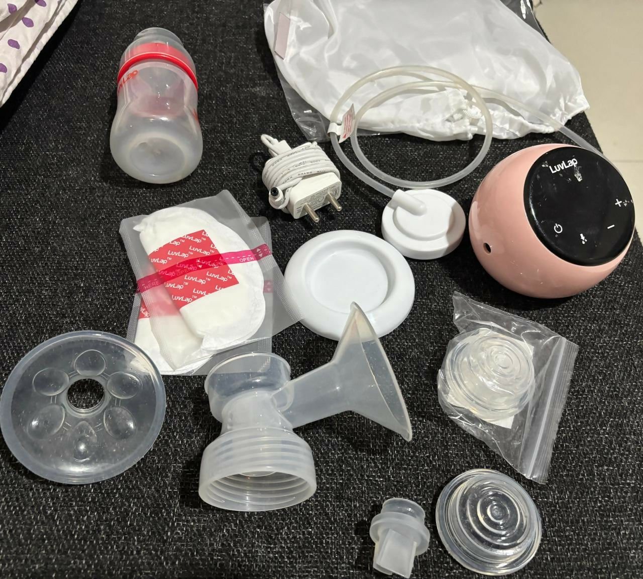 LUVLAP Adore Rechargeable Electric Breast Pump with 2 Phase Pumping in Almost New condition, featuring adjustable pumping settings, comfortable breast cushion, rechargeable operation, and a convenient design for everyday breast milk expression.