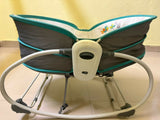 Mastela 5-in-1 Rocker Bassinet in Teal with rocking and bassinet modes, cushioned sleeping area, secure safety harness, and a sturdy multifunctional design for newborns.