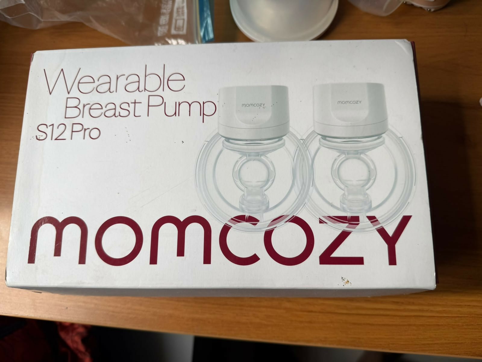 Momcozy S12 Pro Wearable Breast Pump with hands-free wearable design, adjustable suction levels, rechargeable battery, quiet operation, leak-resistant collection cups, and BPA-free components for comfortable milk expression.