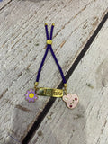 Personalized Bond Band Rakhi with charm featuring custom name personalization, decorative charm detail, comfortable band design, and a thoughtful keepsake for Raksha Bandhan celebrations.