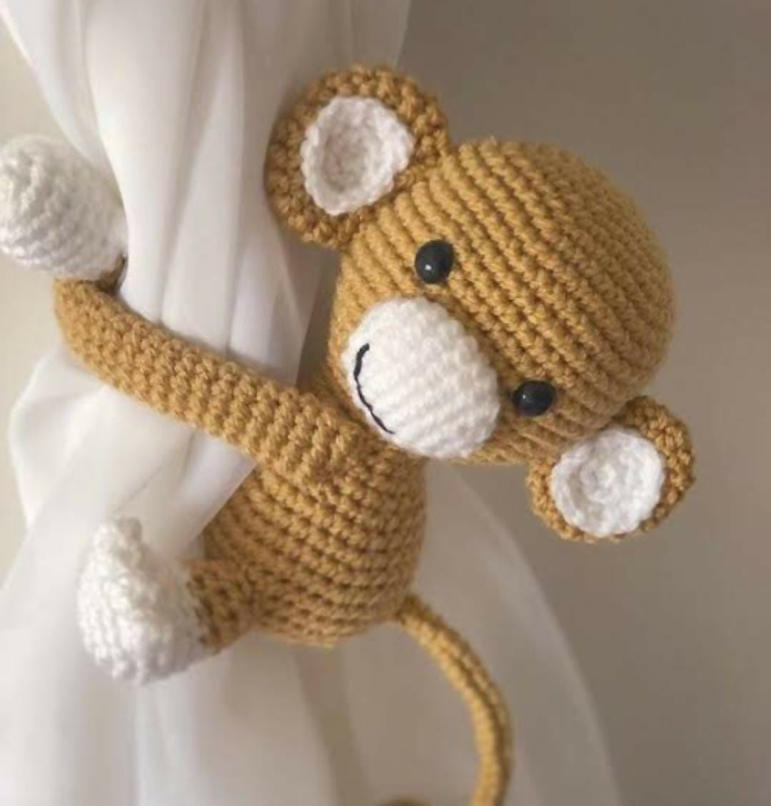 Adorable and functional curtain holders for baby rooms, designed to keep curtains neatly tied while adding a playful touch to nursery decor.