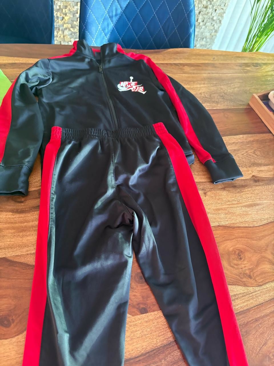 Nike Air trackpant set for kids featuring a coordinated sweatshirt and trackpants, comfortable fabric, sporty design, and everyday wear suitable for play, outings, and casual activities.