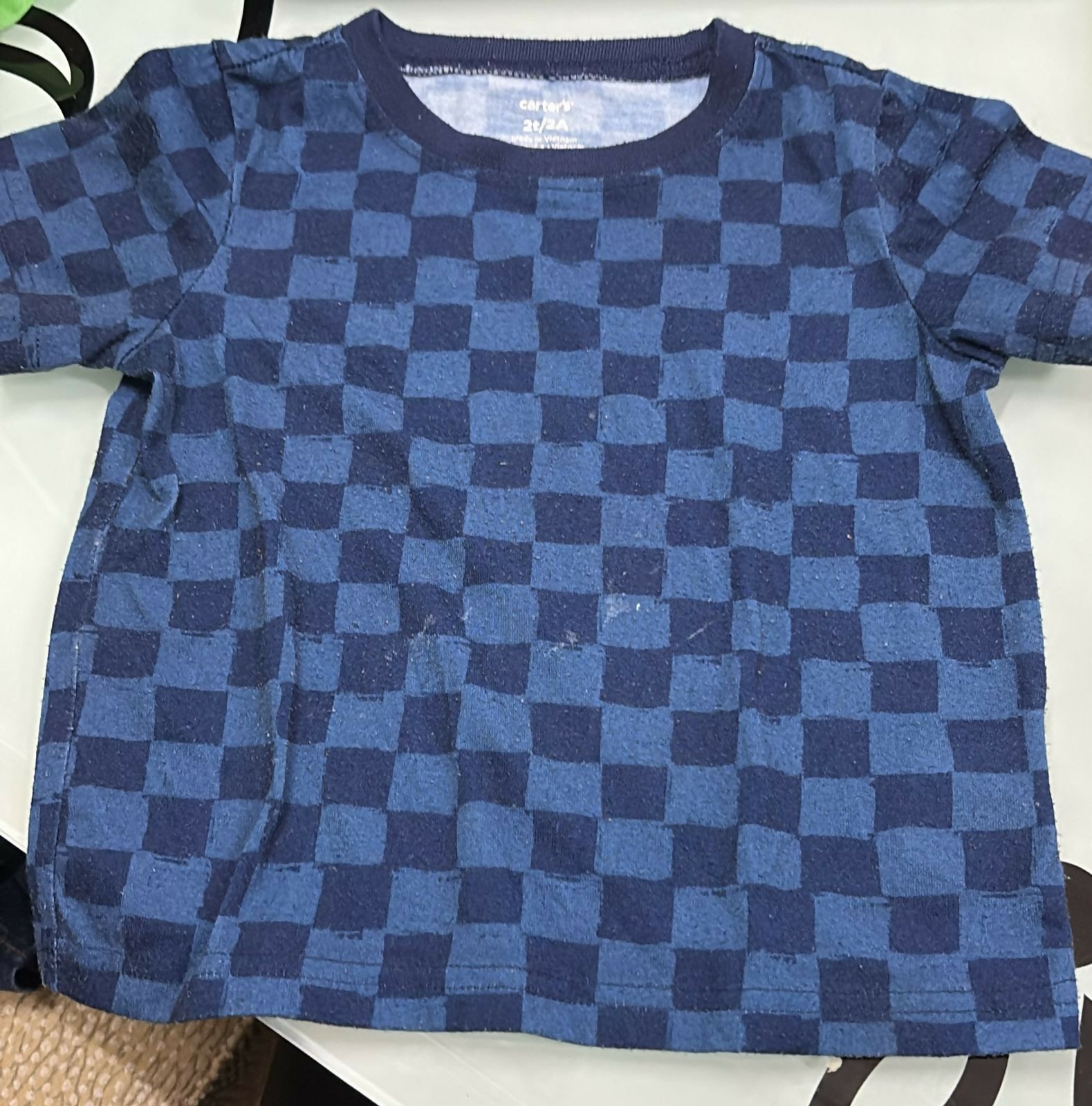 Blue checkered shirt on a white surface