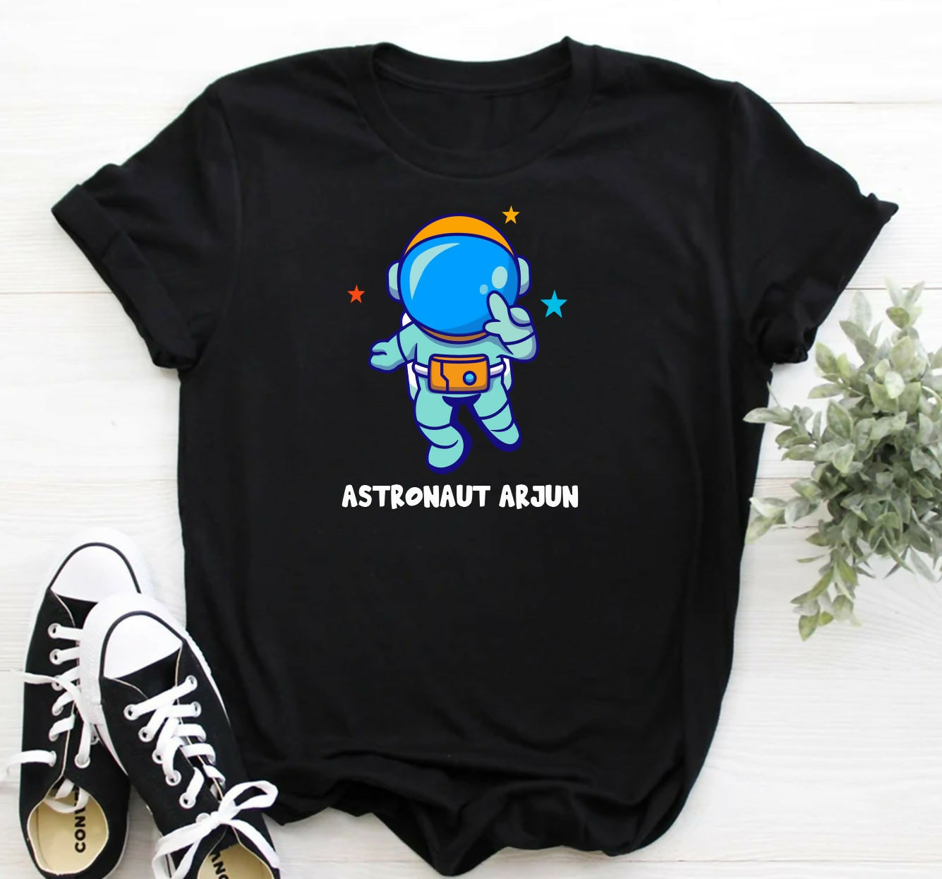Black t-shirt with an astronaut graphic and 'Astronaut Arjun' text on a white background