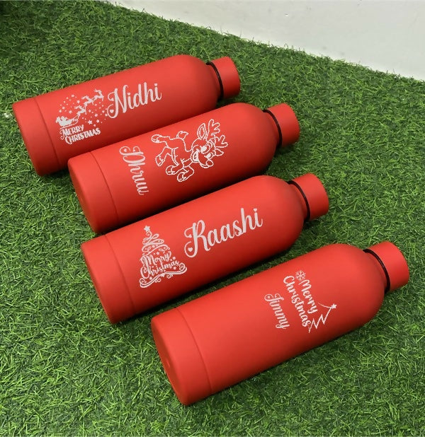 Four red water bottles with personalized names