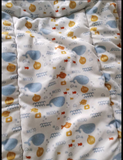 Baby blanket with colorful animal pattern on a white background