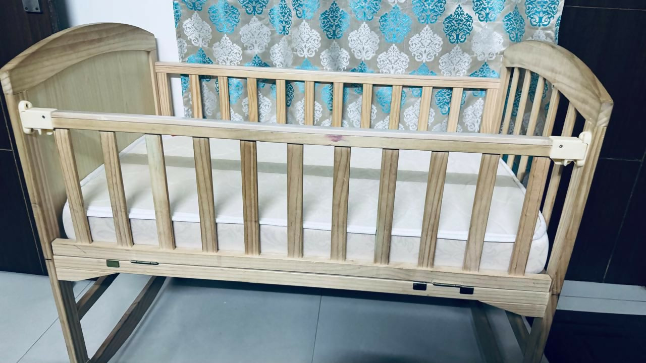 BABYHUG 4 in 1 convertible baby cot with rocking function, cozy sleeping space, sturdy frame, adjustable design, and rocking feature for baby comfort and safe sleep.
