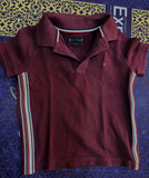 TOMMY HILFIGER maroon polo neck T-shirt featuring soft comfortable fabric, classic polo collar, short sleeves, and a smart casual look for everyday wear and outings.