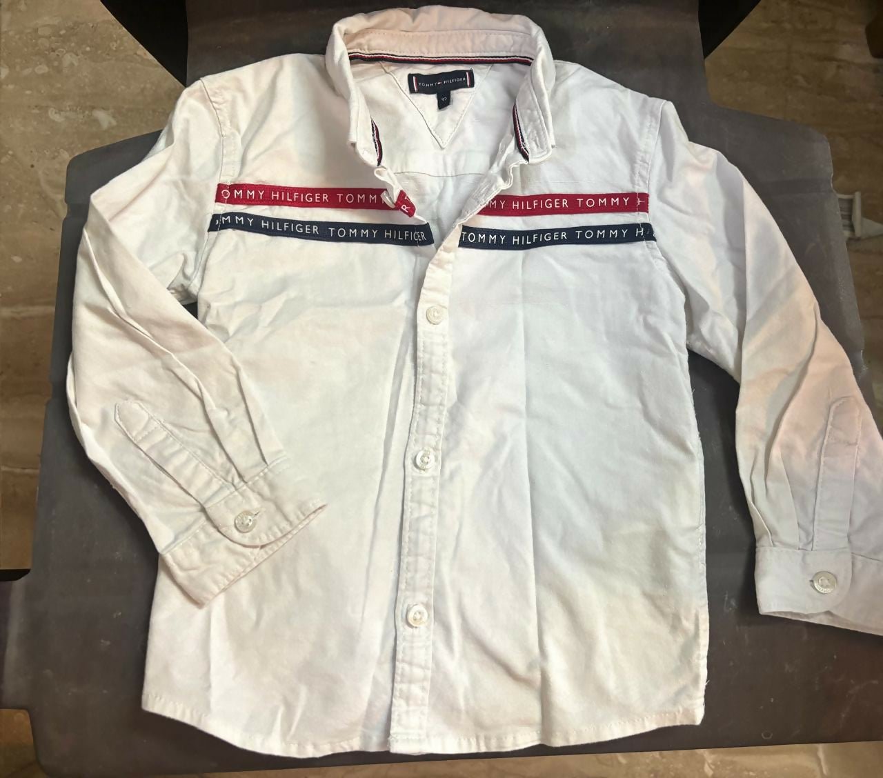 TOMMY HILFIGER white shirt featuring soft comfortable fabric, classic collar design, button-down styling, and a versatile look suitable for casual and formal occasions.