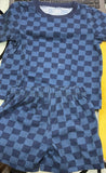 Blue checkered outfit with shirt and shorts on a yellow background