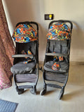 Two baby strollers with colorful seats