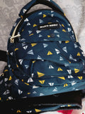 Navy blue backpack with yellow and white triangle pattern on a textured surface