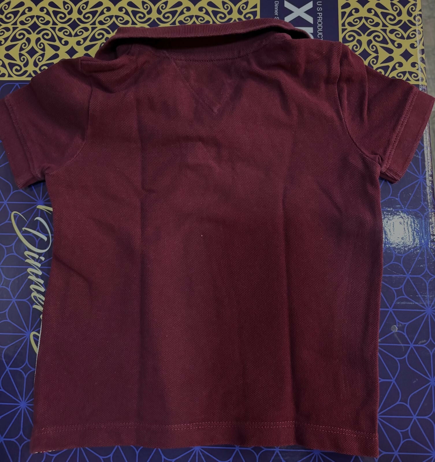 TOMMY HILFIGER maroon polo neck T-shirt featuring soft comfortable fabric, classic polo collar, short sleeves, and a smart casual look for everyday wear and outings.