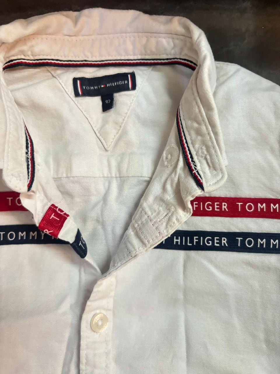 TOMMY HILFIGER white shirt featuring soft comfortable fabric, classic collar design, button-down styling, and a versatile look suitable for casual and formal occasions.