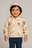 Child wearing a beige jacket with colorful graphics and text
