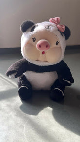 Plush toy resembling a panda with a pig's body on a light surface.