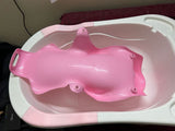 Pink baby bathtub with pink seat on a white background