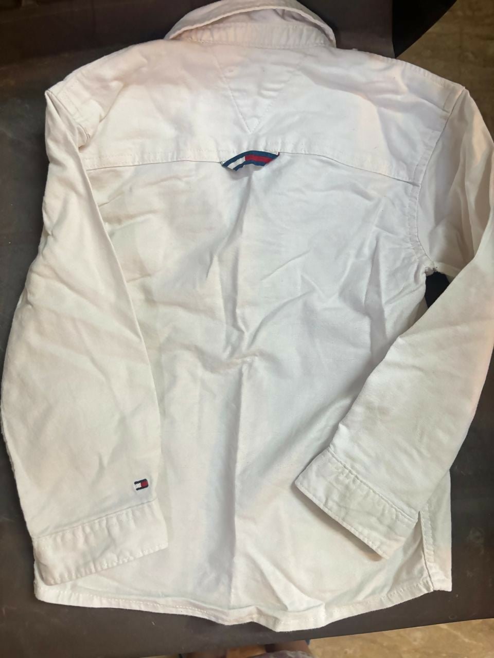 TOMMY HILFIGER white shirt featuring soft comfortable fabric, classic collar design, button-down styling, and a versatile look suitable for casual and formal occasions.