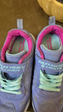 Purple and pink Skechers shoes with green laces