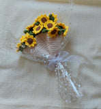 Knitted basket with sunflower design on a beige fabric background