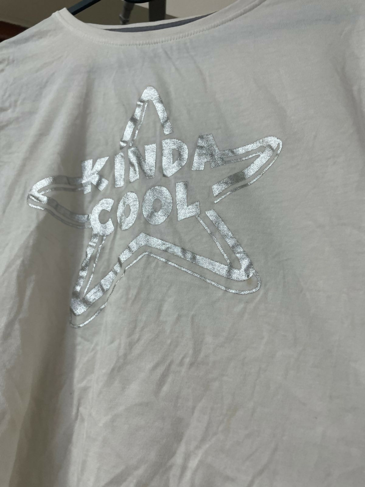 Gray t-shirt with a star-shaped 'KINDA COOL' design on a plain background