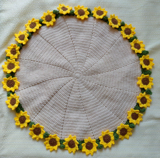 Round crochet mat with sunflower border on a white background