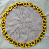 Round crochet mat with sunflower border on a white background
