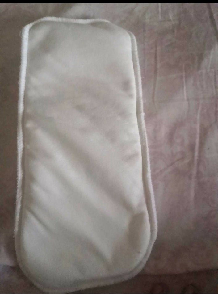 White eye mask on a patterned fabric background