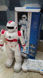 White and red robot toy with blue and white box in the background