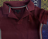 TOMMY HILFIGER maroon polo neck T-shirt featuring soft comfortable fabric, classic polo collar, short sleeves, and a smart casual look for everyday wear and outings.