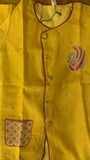 Yellow garment with a floral pocket and embroidered design on a yellow background