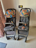 Two baby strollers with colorful covers