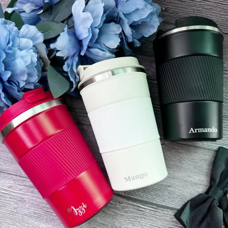 Three insulated travel mugs in red, white, and black