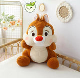 Plush toy resembling a cartoon character on a white surface with a decorative background