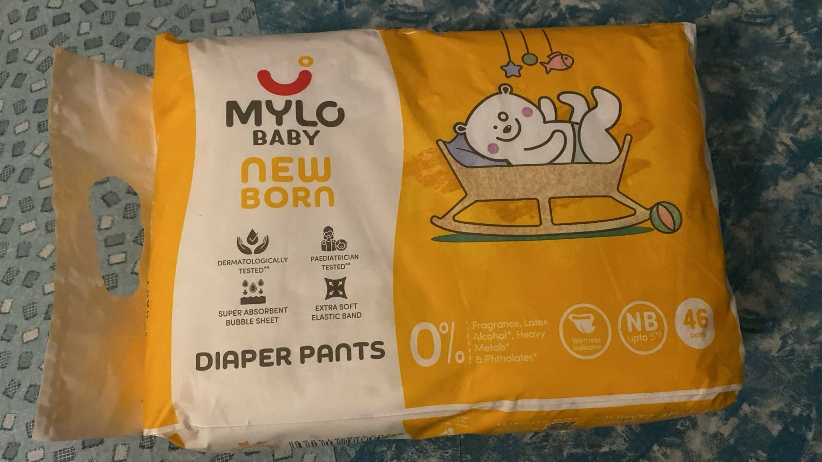 Pack of Mylo Baby Diaper Pants on a textured surface