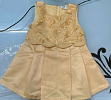 Beige dress with floral embroidery on a blue background