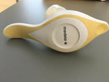 Yellow and white Medela breast pump