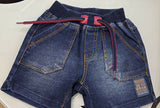 Folded blue jeans with red stitching on a white background
