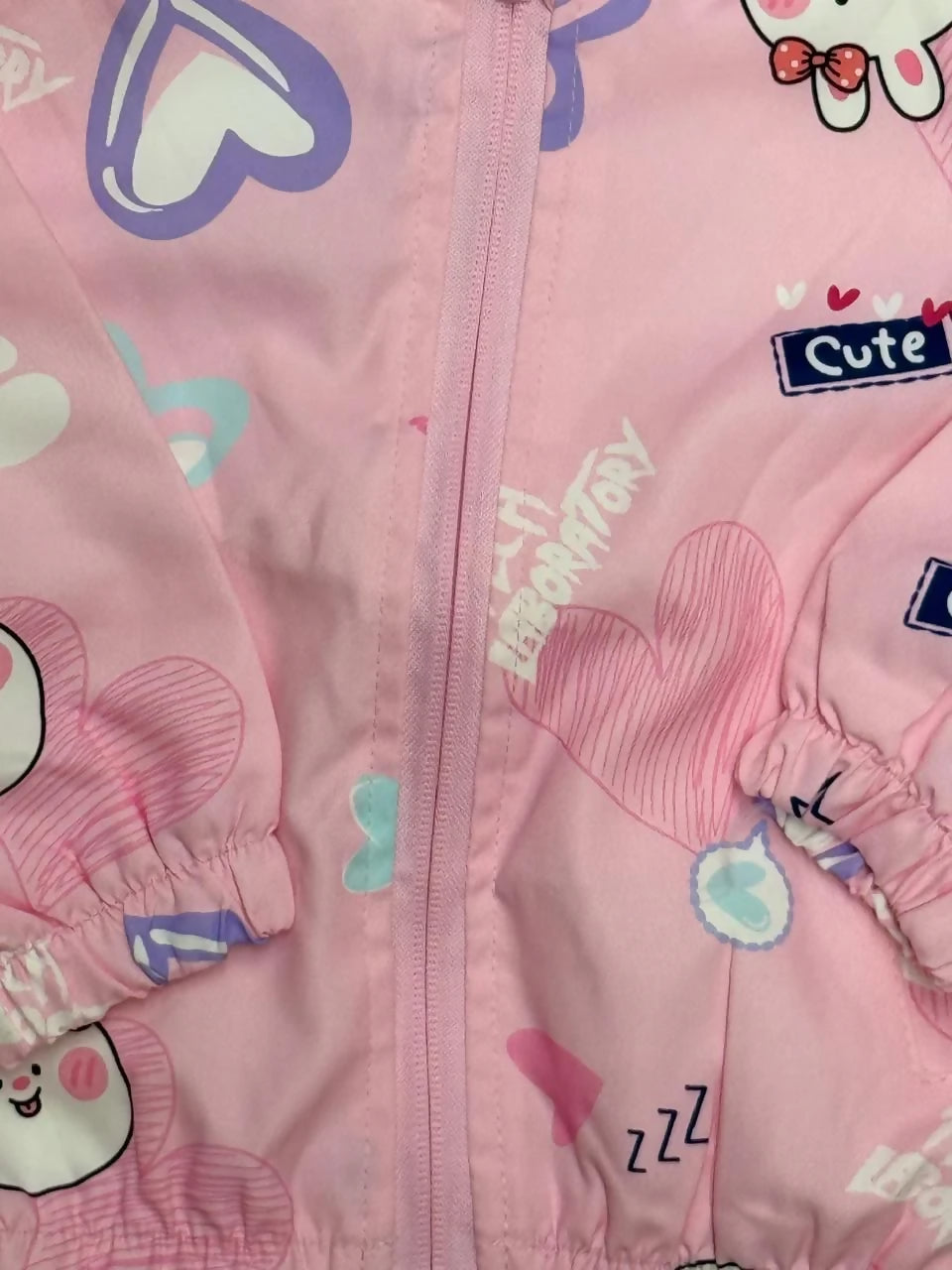 Pink children's jacket with cartoon characters and text