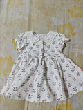 White dress with floral pattern on a floral fabric background