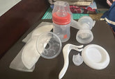 Collection of baby bottle parts on a dark surface