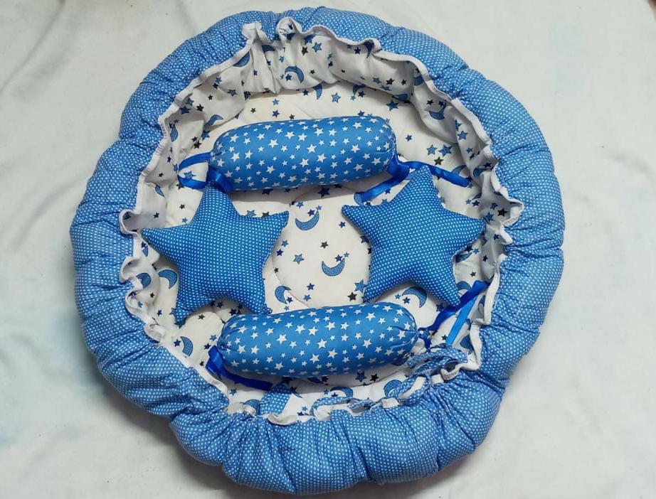 Baby bed with bolsters and star pillows – soft, cozy, and travel-friendly sleep set.
