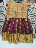 Traditional outfit with a gold blouse and maroon skirt