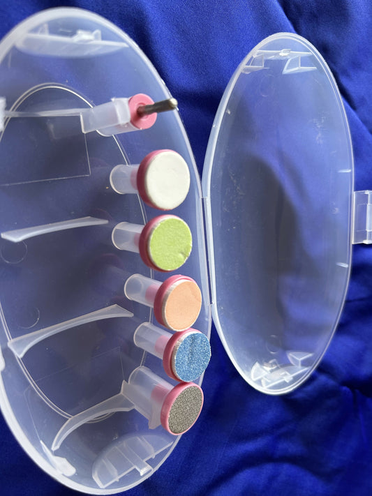 Clear nail buffer with colorful buffers on a blue background